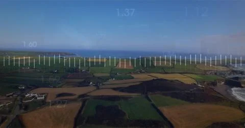 Surveying drone capturing patchwork farmland, hedges, narrow roads over coast 写真素材