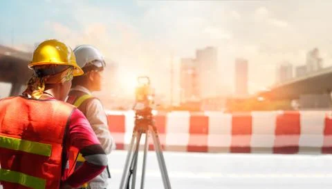 Surveyor builder and engineer working with theodolite transit equipment. Fotos Stock