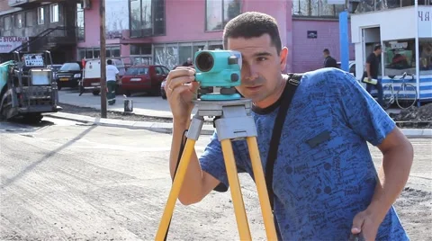 Surveyor on construction site measuring with modern survey equipment. Close up. Stock Footage 41479277
