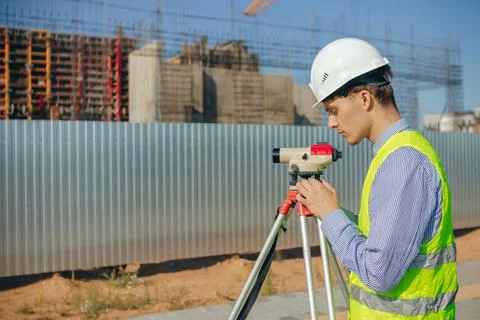 Surveyor engineer adjust optical level on construction site Stock Photos