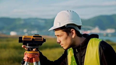 Surveyor engineer is measuring level on construction site. Geodesist ensure Stock Footage 87195882