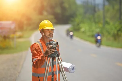 Surveyor engineer worker making measuring with theodolite on road works.surve Stock Photos