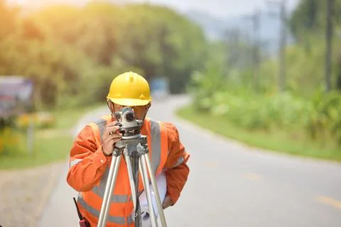 Surveyor engineer worker making measuring with theodolite on road works.surve Stock Photos