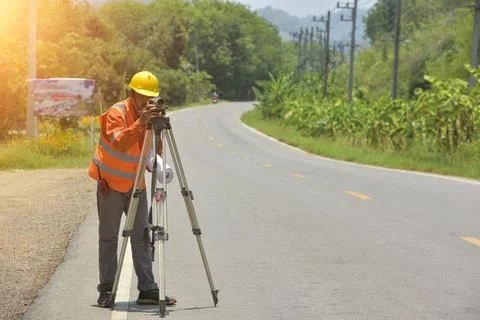 Surveyor engineer worker making measuring with theodolite on road works.surve Stock Photos