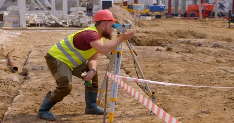 A surveyor shows with hands where to move the peg and fix the point  Stock Footage 147635973
