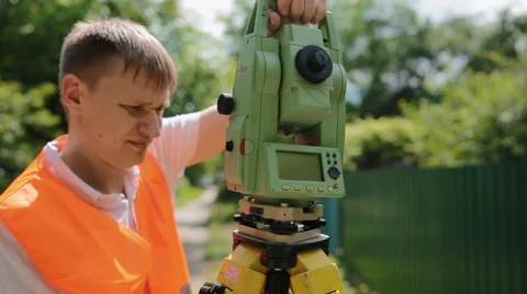 Surveyor at work measuring the distance Stock Footage 67623361