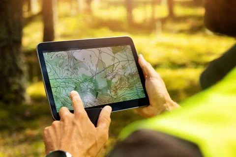 Surveyor working with forest topography map in digital tablet. land surveying Stock Photos