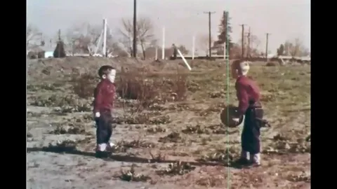 Surveyors survey a new plot of land while two boys watch Video stock 116991108