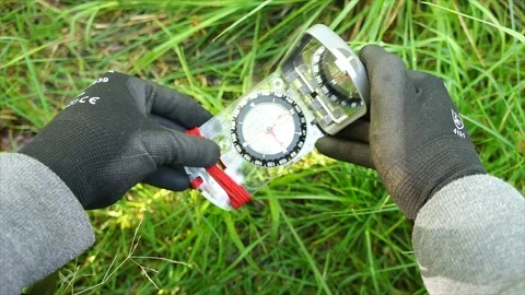 Survival compass for navigation and finding directions in Nature Stock Footage 111856060