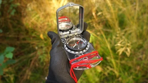 Survival compass for navigation and finding directions in Nature Stock Footage 111856228