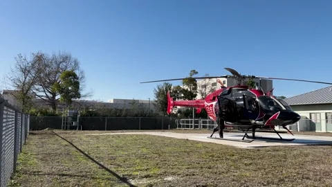 Survival Flight N267SF loading patient at HCA Florida Gulf Coast Hospital Stock Footage 328290481