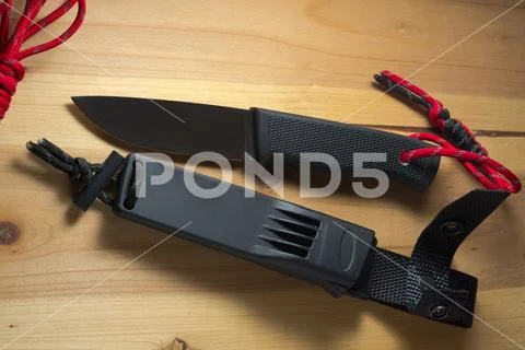 Survival knife with a red paracord on the handle Stock Photos