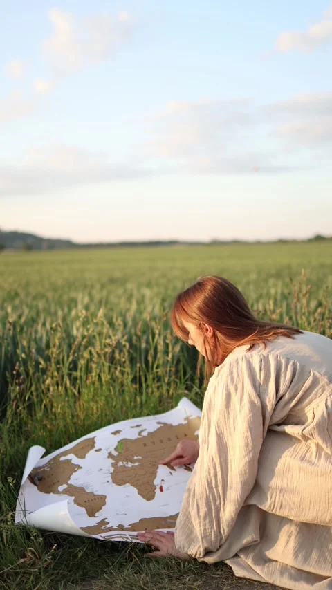 Survivor studies old world map after apocalypse Stock Footage 337941458