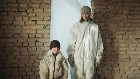 Survivors in protective clothing standing inside shelter after nuclear disaster Video stock 329463962