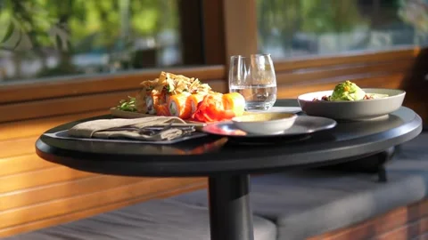 Sushi and rolls are served at a table in a restaurant Stock Footage 282717212