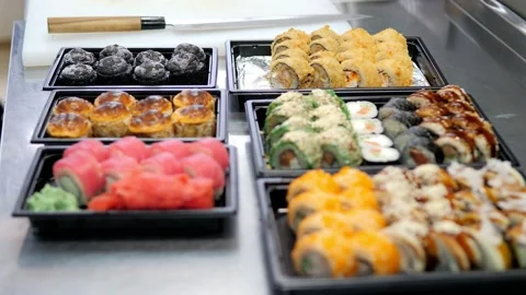 Sushi and rolls set in a plastic box. Delivery service consept Stock Footage 131629565