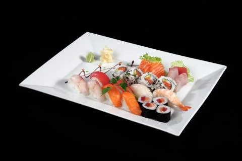 Sushi and sashimi on rectangular white plate Stock Photos
