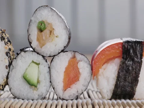Sushi on a bamboo rolling mat - various types - track left to right Stock Footage 75996843