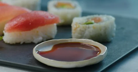 Sushi being dipped in soy sauce Stock Footage 99738448