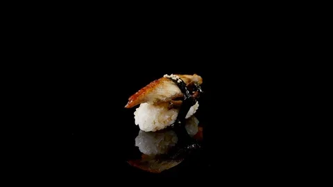 Sushi on black background rotating Stock Footage 74502879