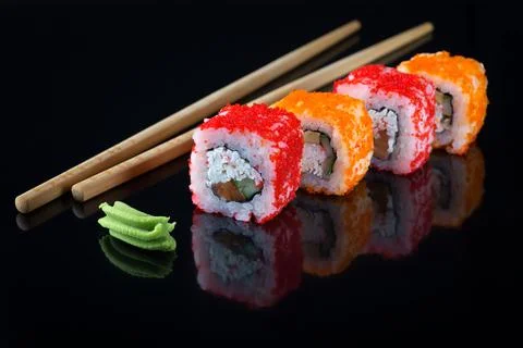 Sushi on a black background with space for text Asian cuisine. Stock Photos