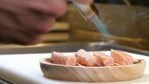 Sushi Chef Cooking Salmon with a Torch Stock Footage 80557246