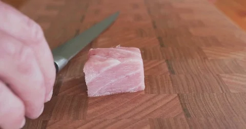 Sushi chef cuts thin slices of fatty belly tuna, also called toro, otoro Stock-Footage 115528702