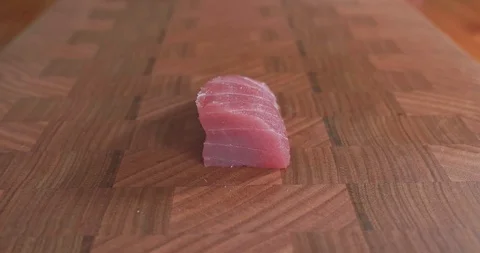 Sushi chef cuts thin slices of tuna, also called toro, maguro, otoro or chutoro Video stock 115528783