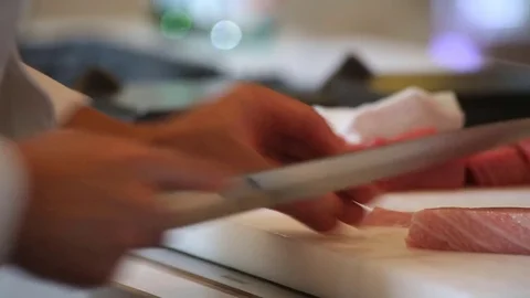 Sushi chef cutting fish Stock Footage 77672096