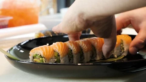 Sushi chef decorates sushi set Stock Footage 84697399