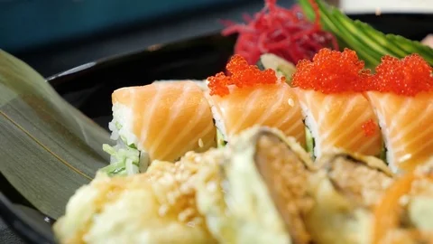 Sushi chef decorates sushi set with caviar of flying fish Stock Footage 84702406