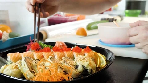 Sushi chef decorates sushi set with caviar of flying fish Stock Footage 84702593
