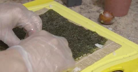 An sushi chef making and rolling a sushi rolls Stock Footage 131932652