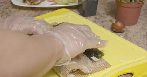 An sushi chef making and rolling a sushi rolls Stock Footage 131932720