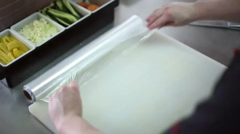 A sushi chef prepares the bamboo mat to tighten the roll Stock Footage 59698033
