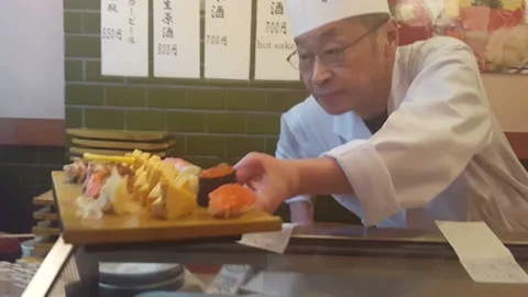Sushi chef prepares platter Stock Footage 134041414