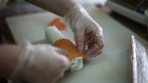 A sushi chef prepares rolls with a bamboo mat Stock Footage 59698305
