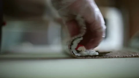 A sushi chef prepares rolls with a bamboo mat Stock Footage 59698510