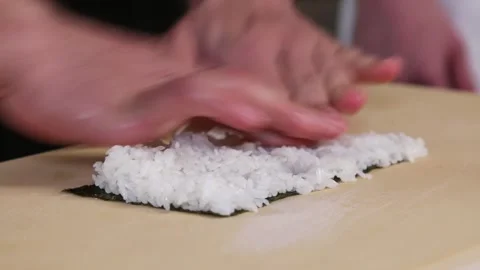 Sushi chef preparing rice for sushi roll Stock Footage 131005746