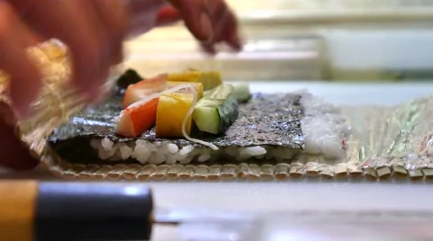 Sushi Chef Preparing Salmon Peach Futomaki Roll. A sushi-man cooking Stock Footage 64673371