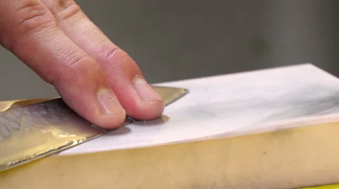 Sushi Chef Sharpening his Knife Blade with a Pink Stone Stock-Footage 52634506