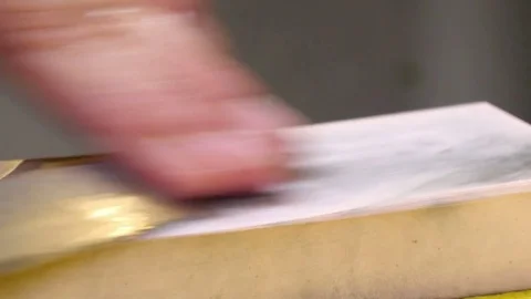 Sushi Chef Sharpening his Knife Blade with a Pink Stone Stock Footage 80557155