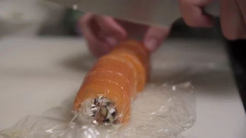 Sushi chef slices salmon roll Stock Footage 167339886