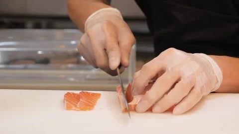 Sushi Chef Slicing Fresh Salmon for Sashimi with Professional Knife Stock Footage 333489622