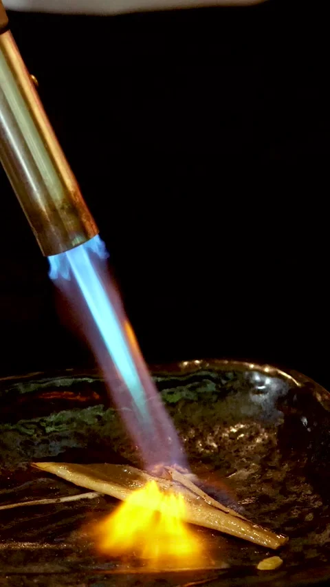 Sushi Chef Using Blowtorch to Sear Anago Eel on Ceramic Plate Stock Footage 334161699