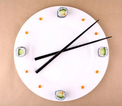 Sushi clock, time concept with caviar on a white plate Stock Photos