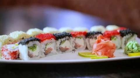 Sushi dish on black table in motion rolls set presentation Stock Footage 83041672