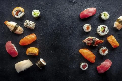 Sushi frame, a flat lay, top shot. Rolls, maki, nigiri on a black slate 스톡 사진