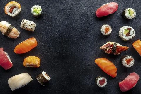 Sushi frame, overhead flat lay shot. Rolls, maki, nigiri on a black slate Stock Photos
