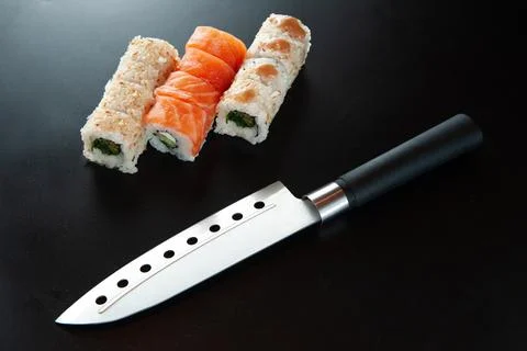 Sushi with knife on a dark background Stock Photos
